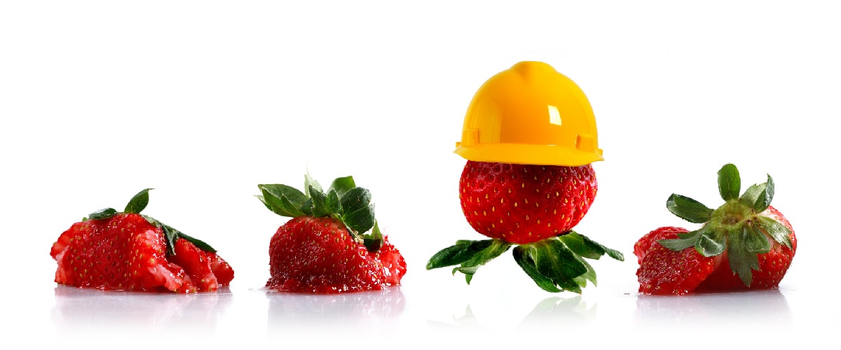 3 smooshed strawberries 1 intact strawberry in construction hat